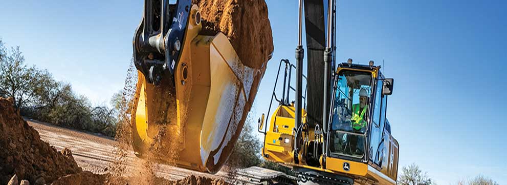 Mid Sized john deere excavator digging a hole at a construction site