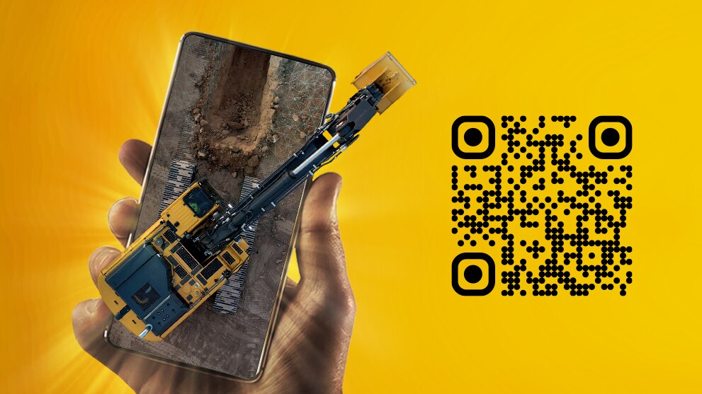Hand holding a mobile device with an excavator digging a trench to represent augmented reality.