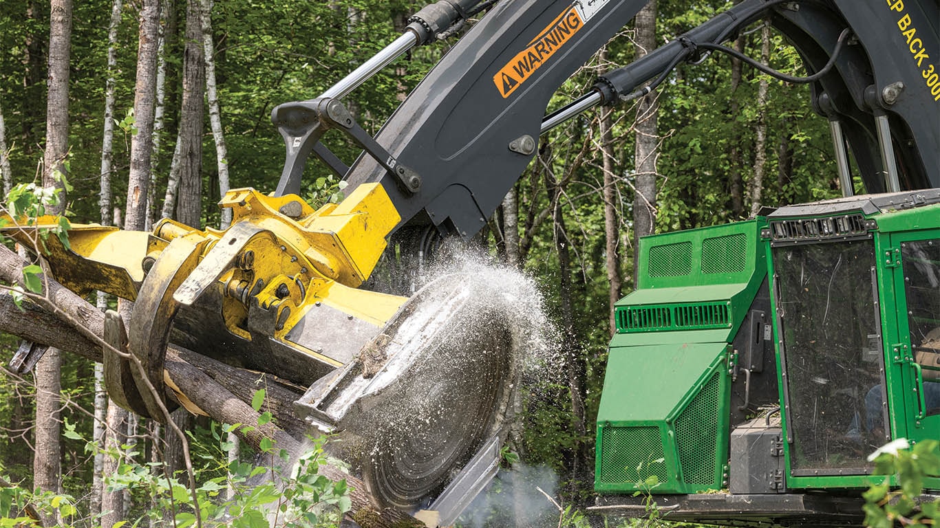 Close-up image of a feller bunch blade cutting logs.