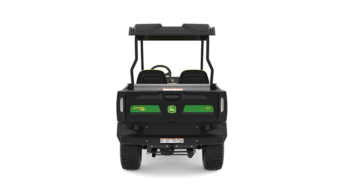 A green Gator with two yellow seats and large cargo box facing backward on a white background.