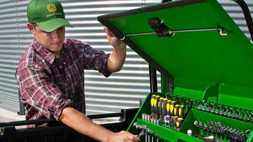 A man opening a John Deere tool chest