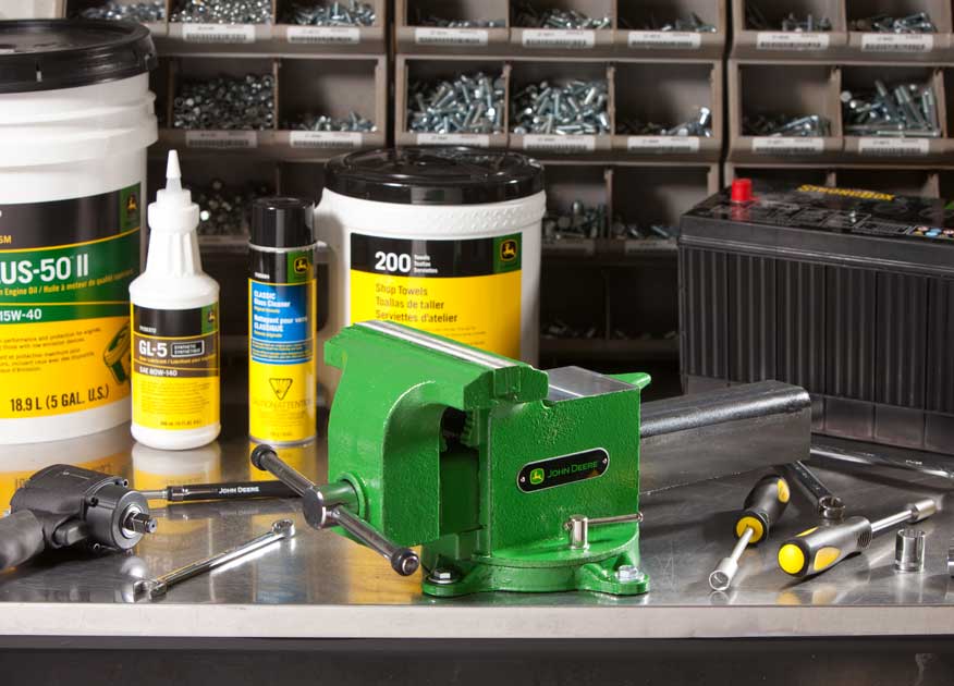 A variety of tools and cleaning supplies on a workbench.