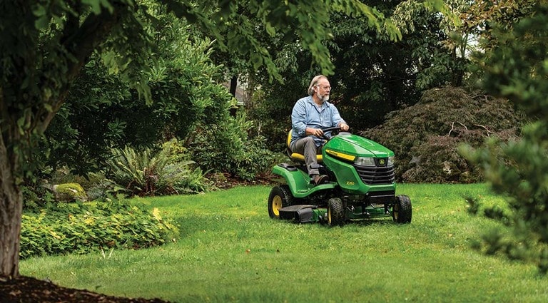 A person mowing his lawn with a X350 Mower