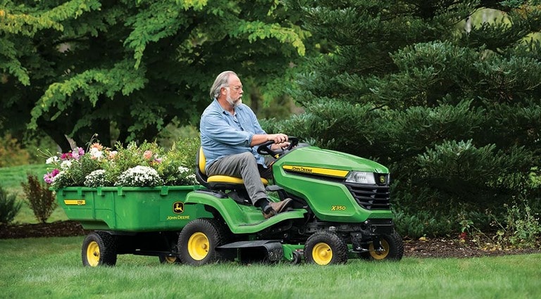 A person using his X350 Cart Attachment to transport flowers.