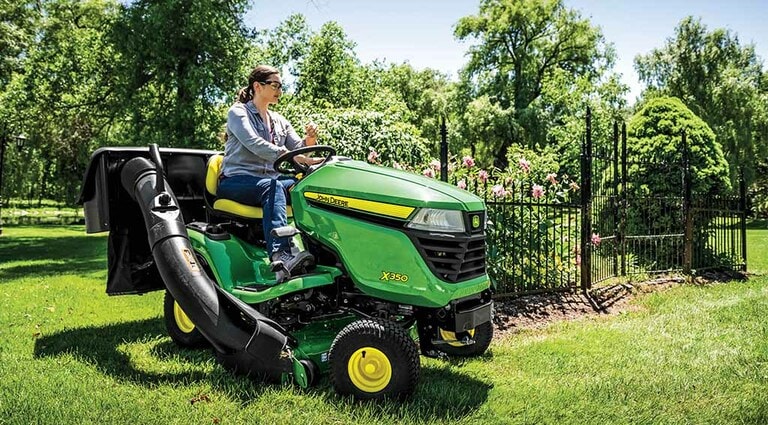 A person mowing her lawn with a X350 Mower