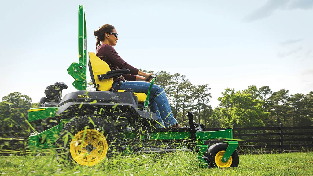 A woman mowing her lawn with a John Deere Z760R ZTrak™ Zero-Turn Mower.
