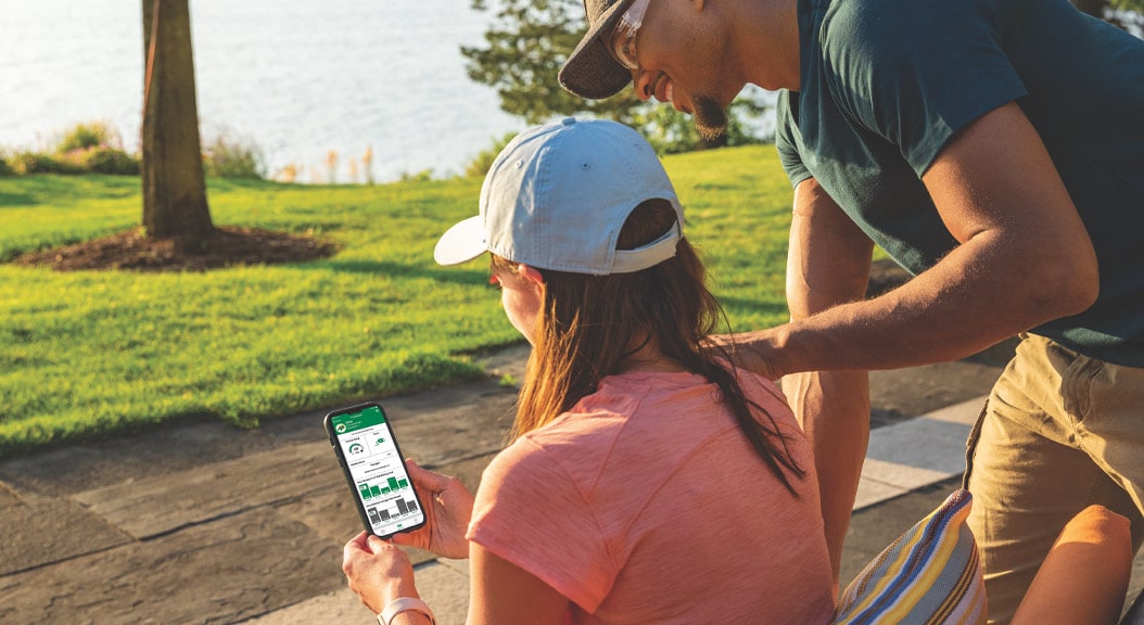Couple viewing the MowerPlus™ app
