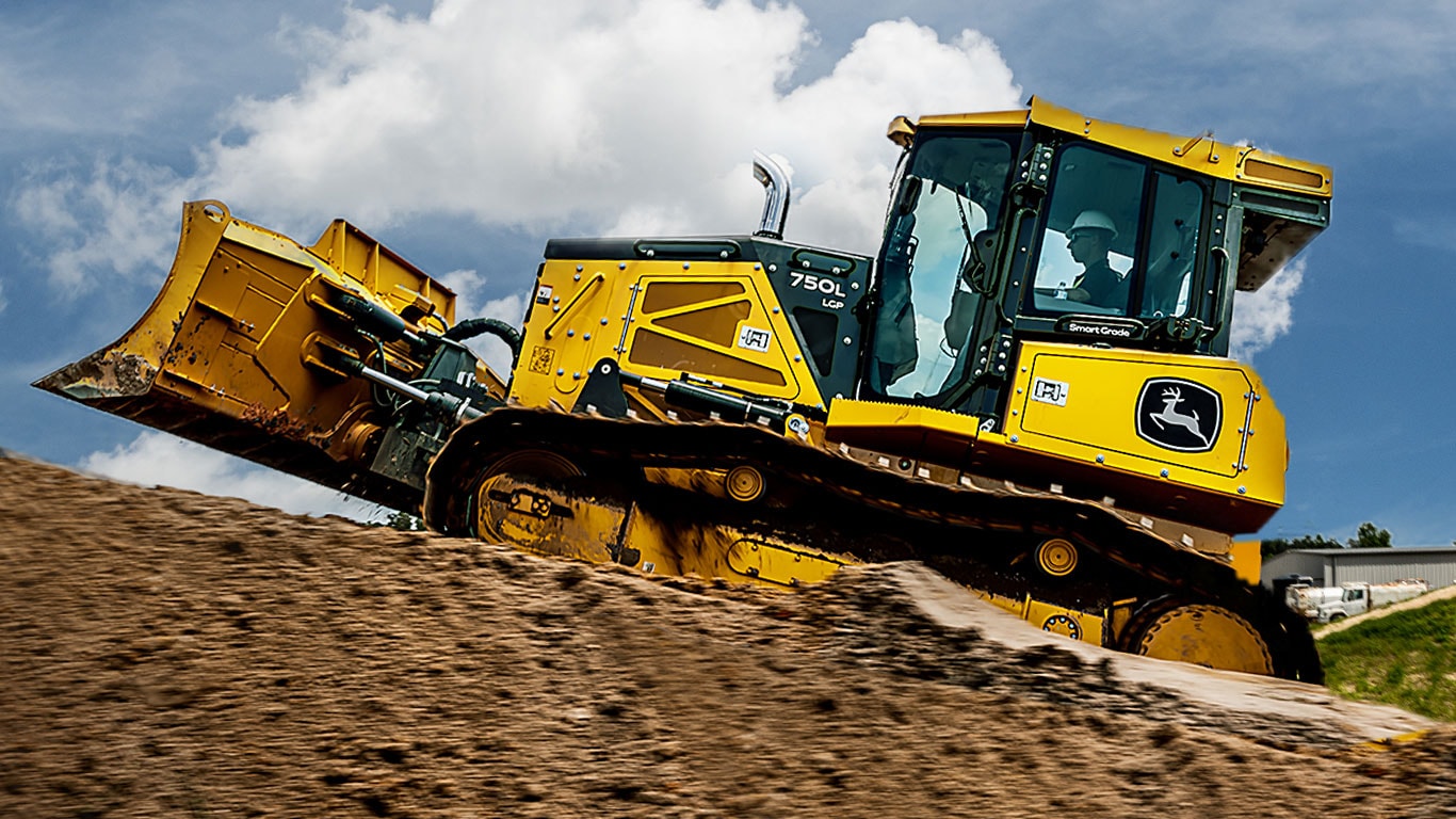 750L Mid-Size Dozer driving up a dirt pile