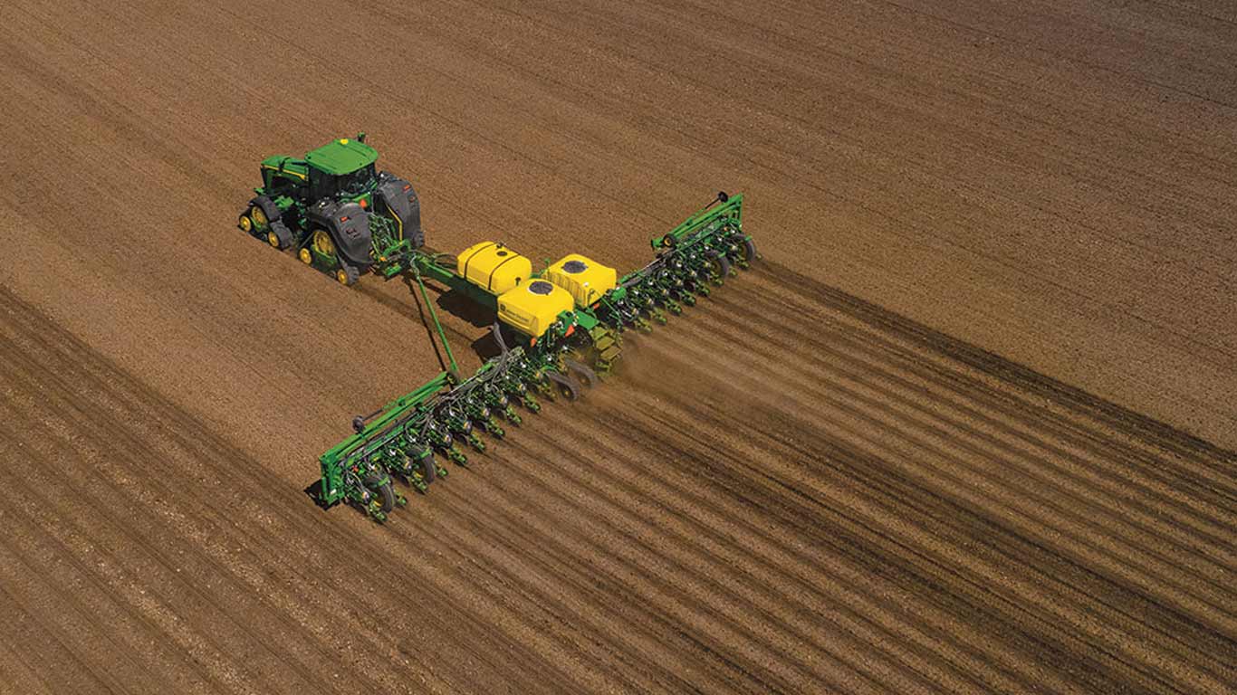 Aerial view of 8RX tractor planting in a field