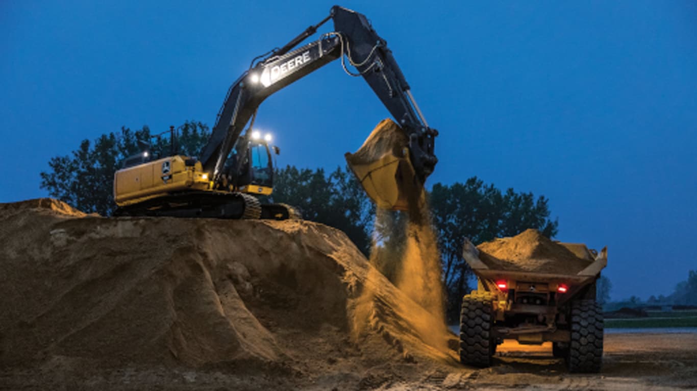 John Deere construction equipment lifting up the dirt