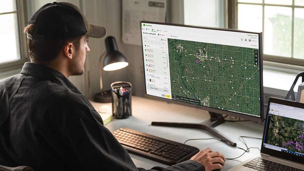 Man on John&nbsp;Deere Operations Center on desktop computer