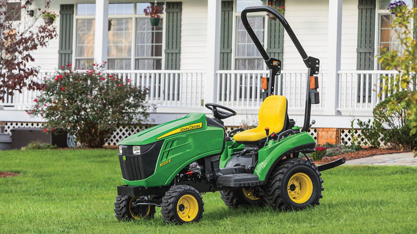 1023E Compact Tractor on lawn in front of house