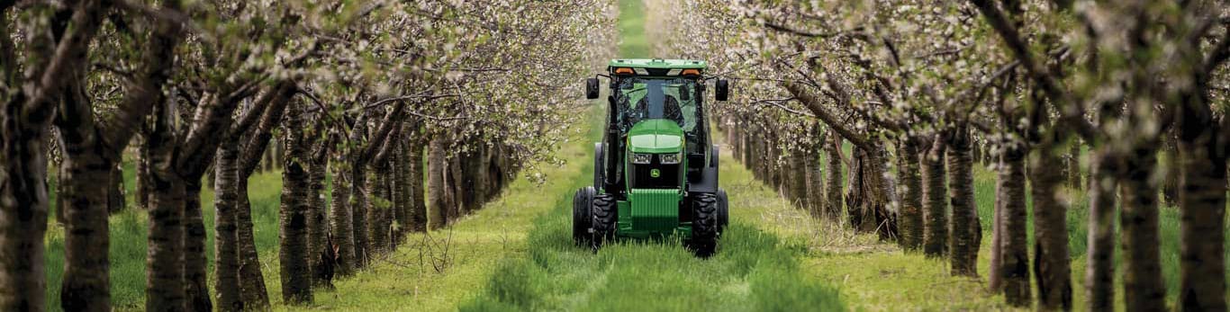 Image of a tractor moving through trees