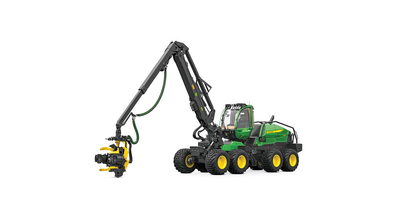Green and yellow forestry machine with an extended arm holding a cutting attachment.