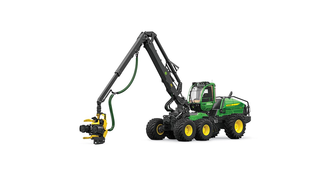 Green and yellow forestry machine with an extended arm holding a cutting attachment.