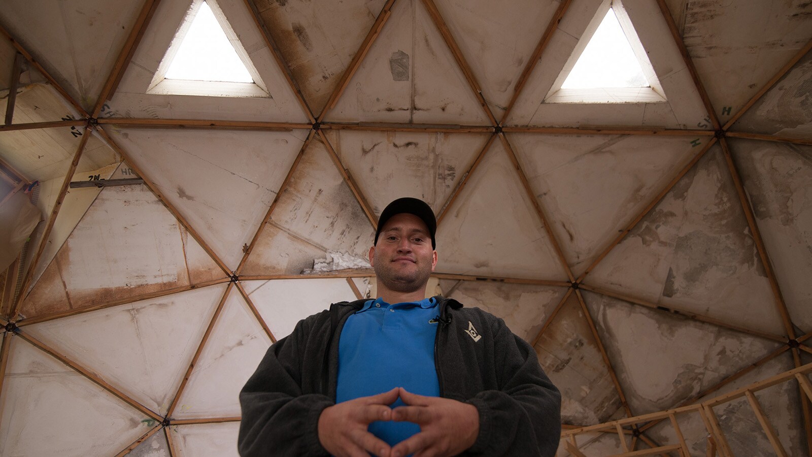 Gene Stull stands inside his under-construction dome structure