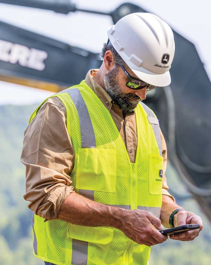 A construction worker looks at Operations Center data