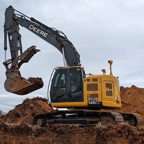  A 245G LC Excavator digging on a jobsite.