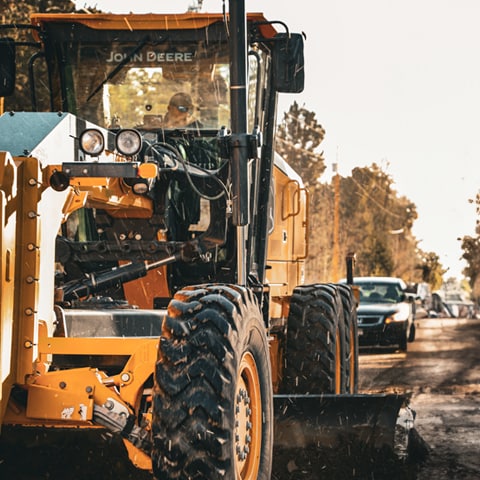  A Motor Grader grading a road.