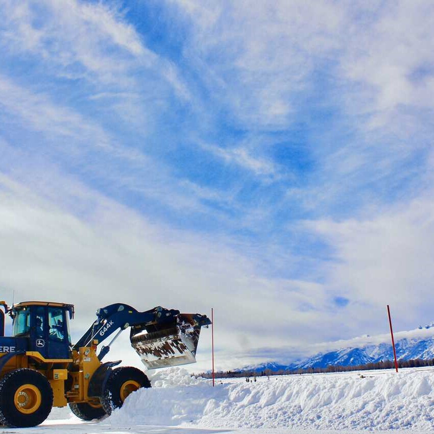 John Deere 644K Wheel Loader driving through the snow