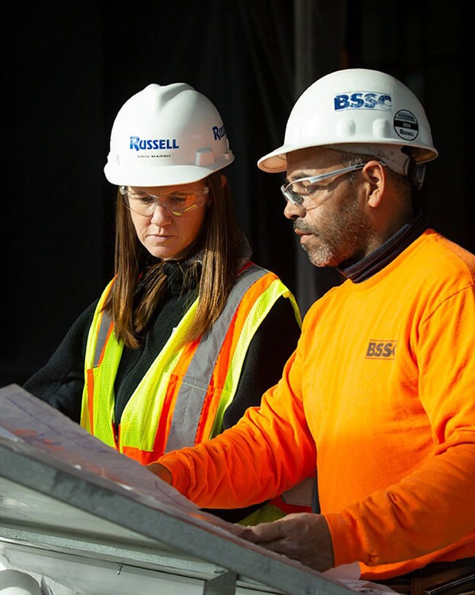 Project Manager Erin March reviews the blueprints for the new museum project with a sub-contractor.