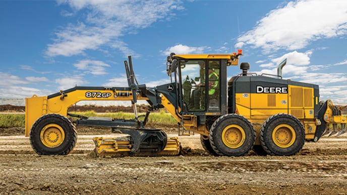 An 872GP SmartGrade™ Motor Grader helps level the highway surface on a jobsite in Montana.
