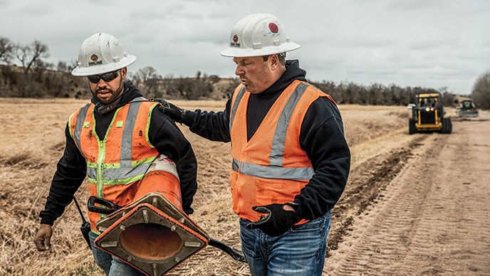 CenCon of Kansas owner Ryan Rietzke and construction manager Trent Rietzke walk together at a jobsite in rural Nebraska. 