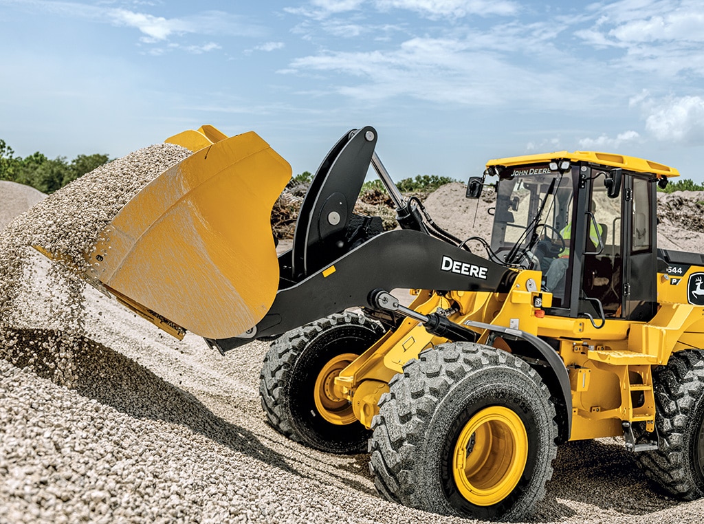 For Ajax Paving, the 644 P-Tier Wheel Loader bucket digs into a gravel pile on a jobsite in North Venice, Florida.