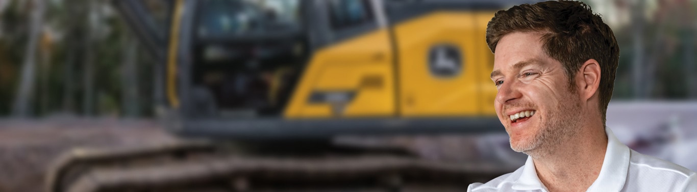 Person in the foreground with construction equipment in the background at an outdoor job site.