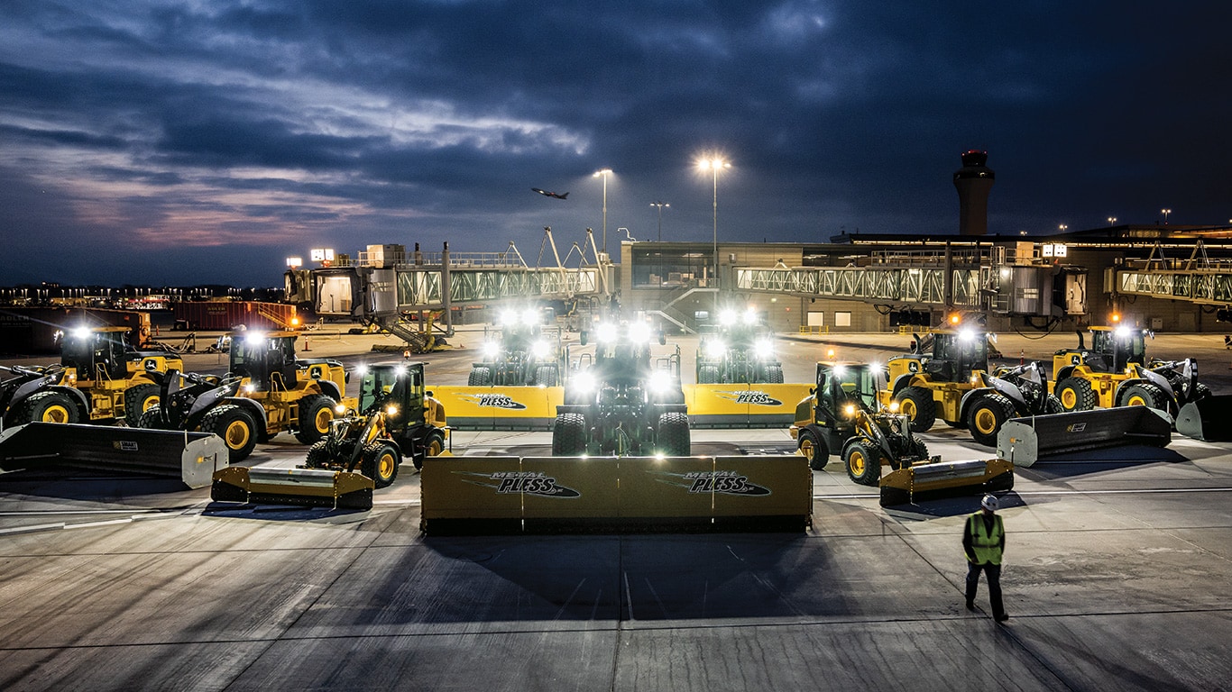 SAaron Kaden, Fleet Asset Superintendent, walks past a fleet of John Deere Wheel Loaders at Kansas City International Airport.