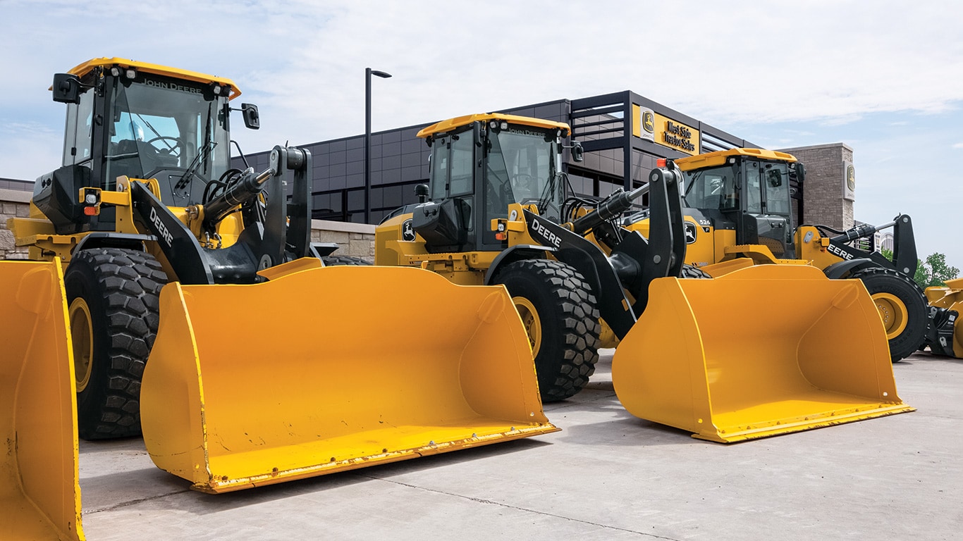 Three brand new P-Tier Wheel Loaders are sitting front of West Side Tractor Sales headquarters.