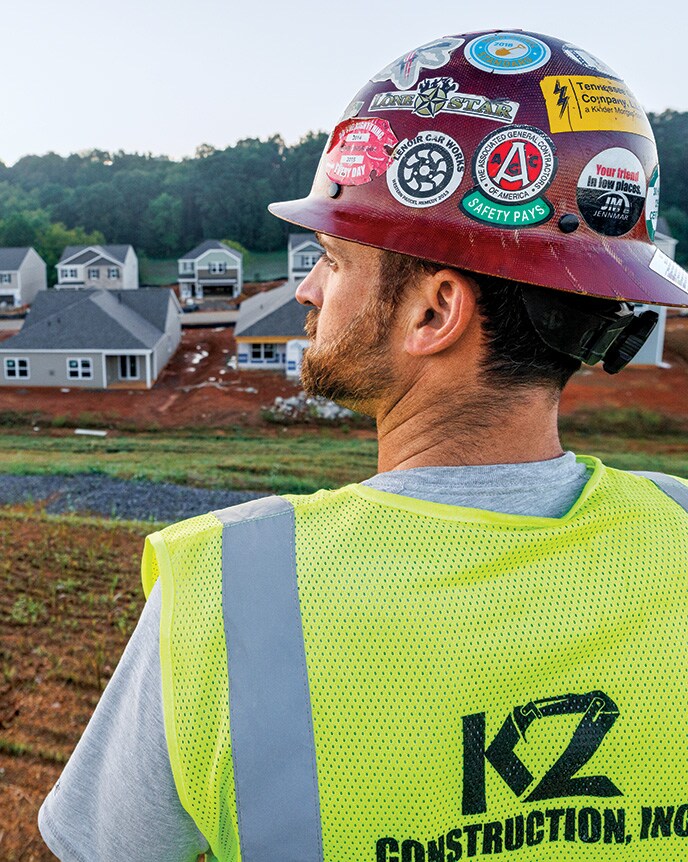 Thomas Karczmarczyk of KZ Construction looks across a housing development jobsite.