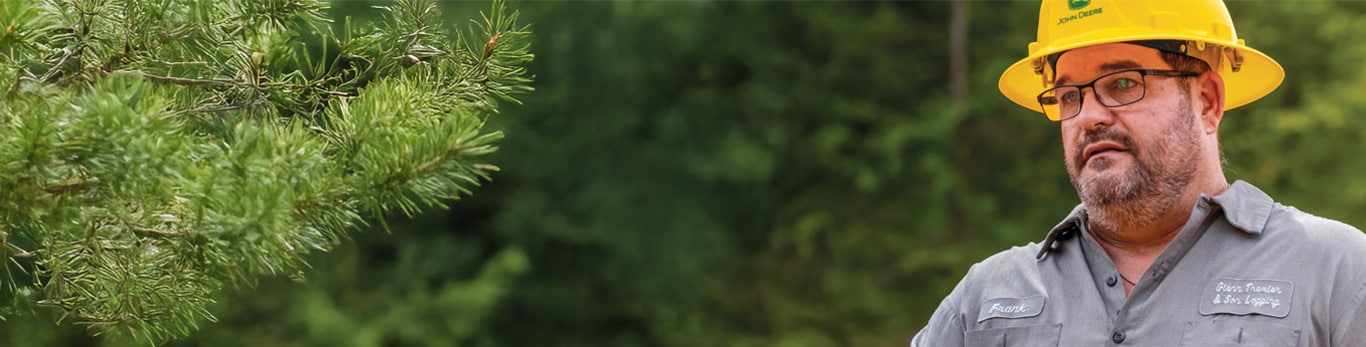 Frank Trexler stands in front of trees and explains the focus of Trexler & Sons is to try to maximize production while minimizing fuel use and machine wear.