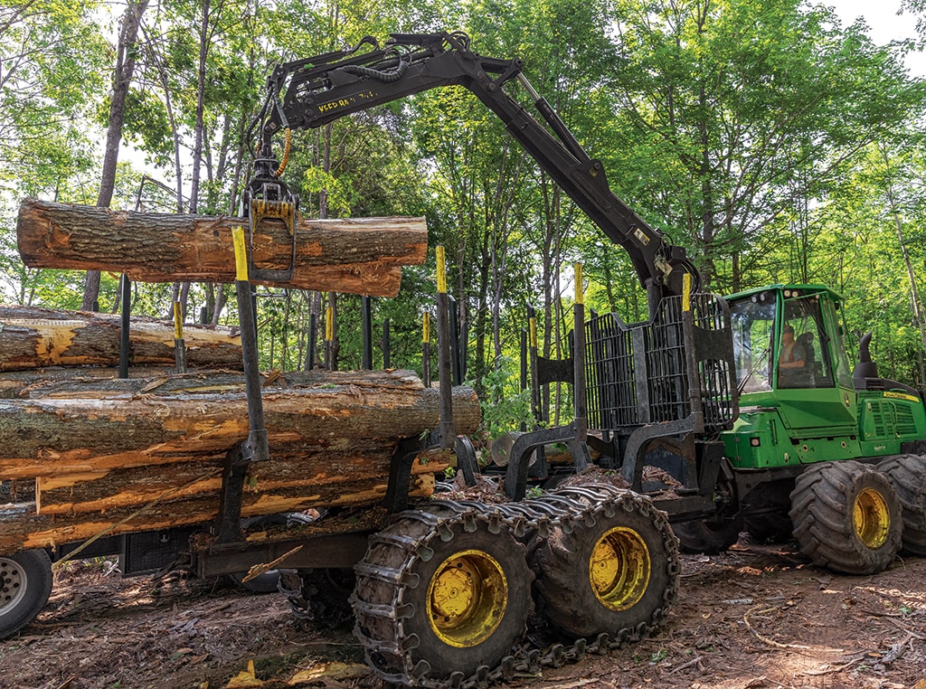 Two logs are placed onto a 1210G Forwarder as Eli prepares to drive to the landing site.