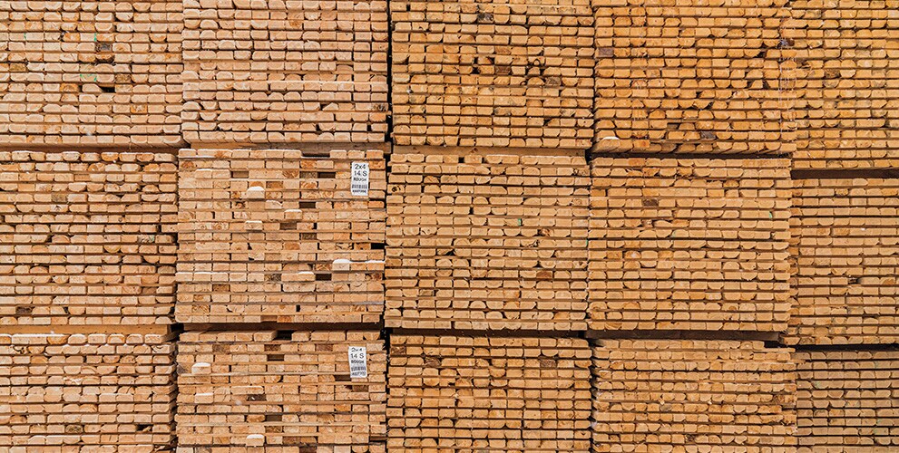 Rough-cut green lumber sits outside in massive stacks before entering the drying kiln at the Pleasant River Lumber sawmill.
