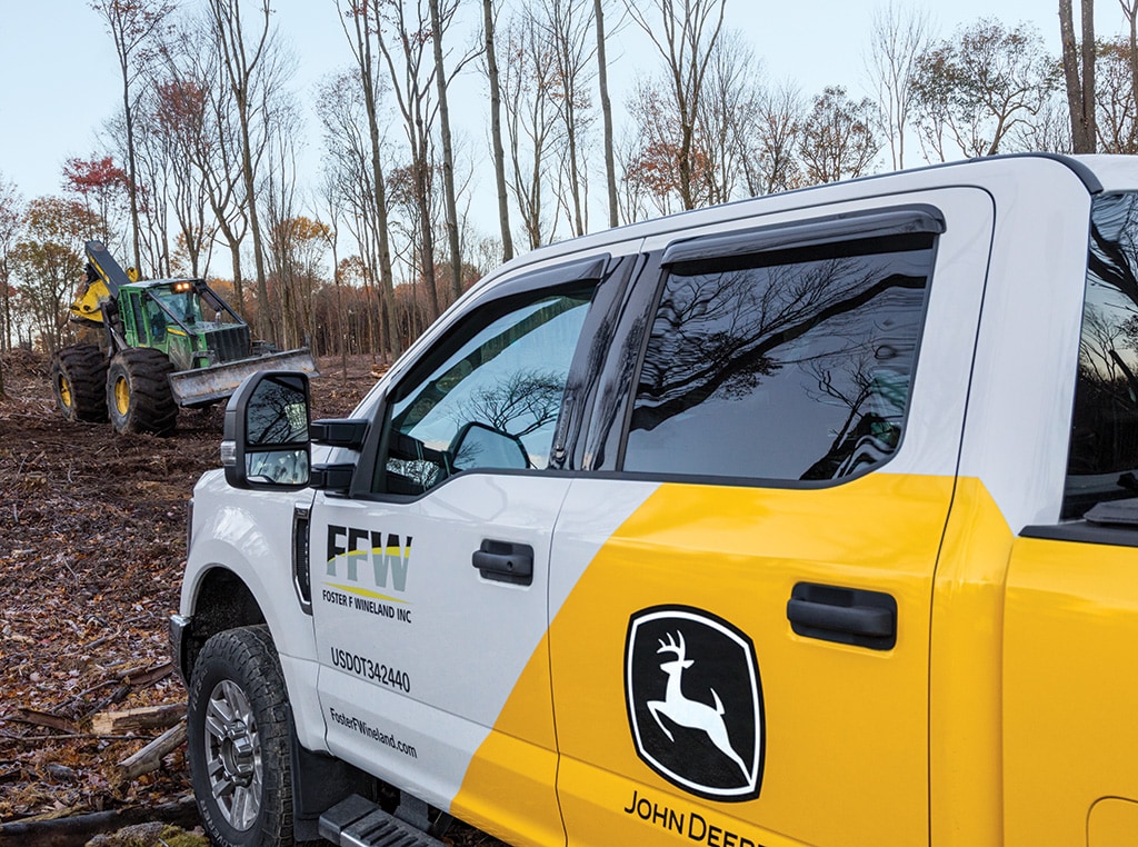 Foster F Wineland service truck in the foreground and 848H Skidder in the background.