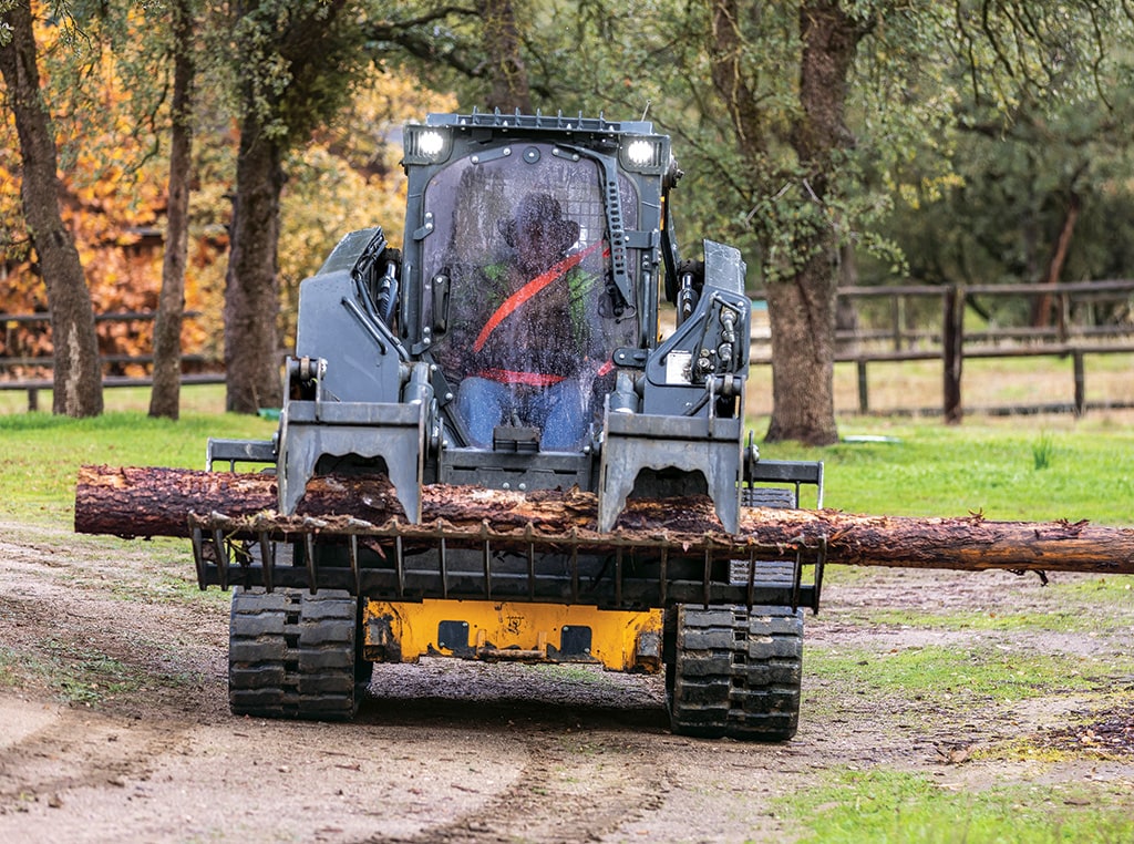 Messer Team uses a skid steer to move logs around a worksite.