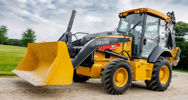 John&nbsp;Deere 310 X-Tier electric backhoe loader on a gravel road.