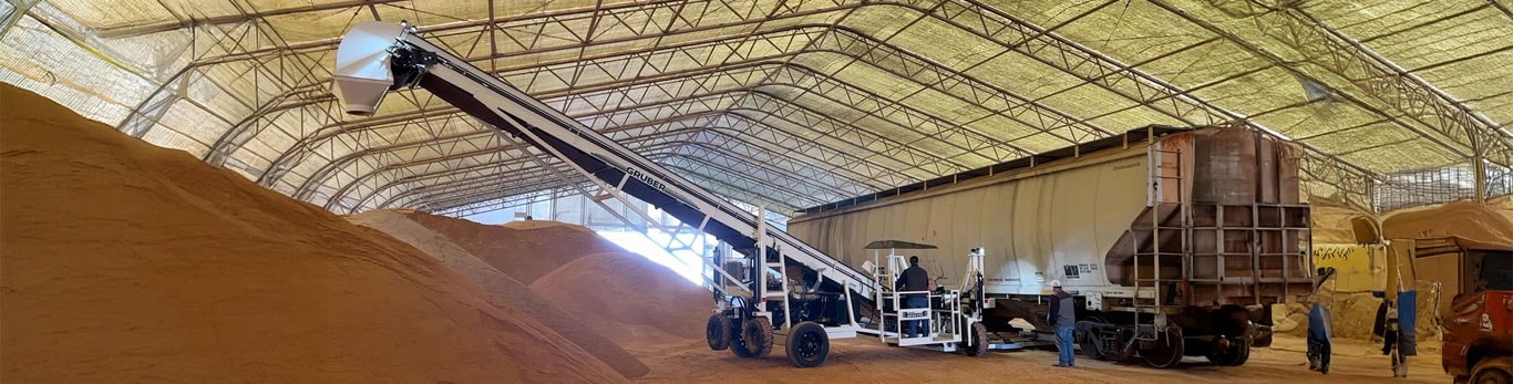 Gruber Manufacturing material conveyor unloading material on a jobsite.