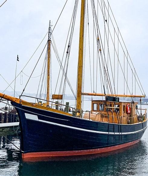 Petersen Tegl’s wooden sailing ship docked in the harbor