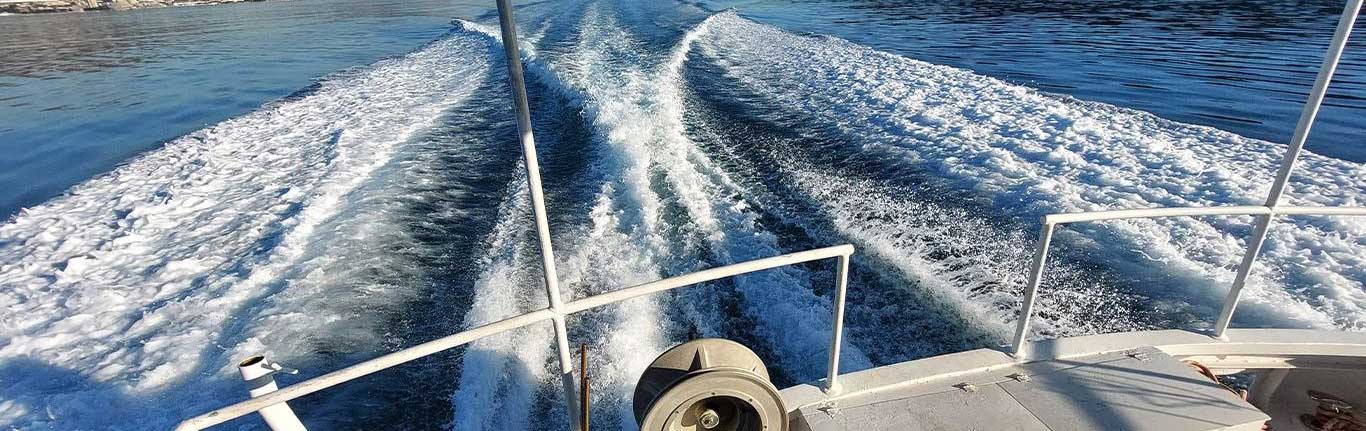 A view from the back of the boat showing the water wake trailing behind, while patrolling Croatia’s coastline.