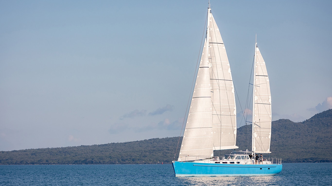 A side view of the Wind Spirit expedition yacht sailing on a body of water