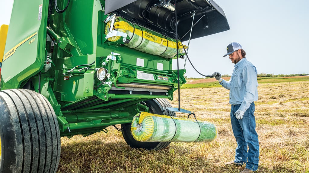 Image of person using Net Lift Assist on Round Baler