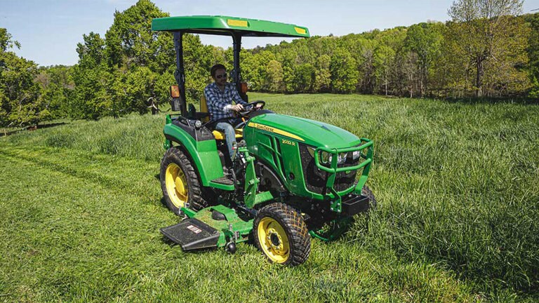 Man mowing grass with a 20324 tractor