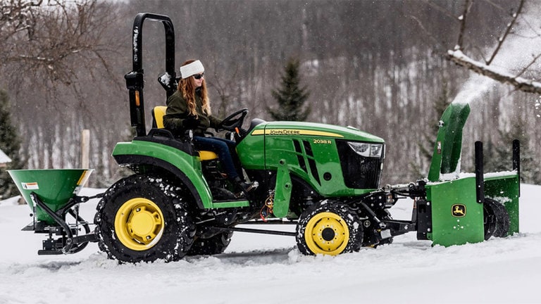 Woman blowing snow with a 2038r tractor