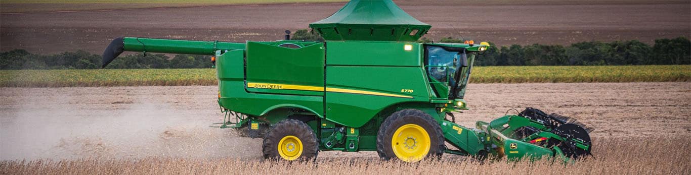 Cosechadora John Deere trabajando en el campo, vista lateral