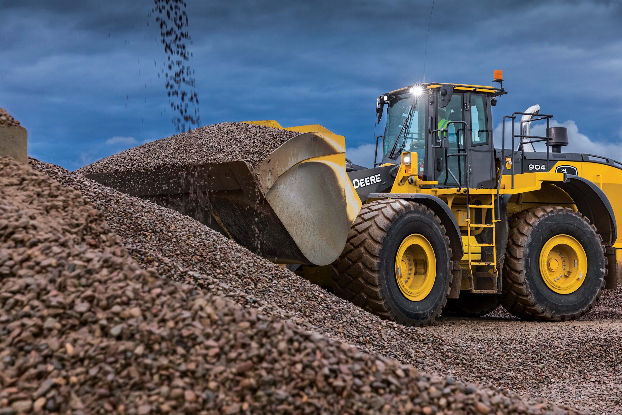 John Deere 904 P-tier Wheel Loader scooping gravel out of a pile on the job