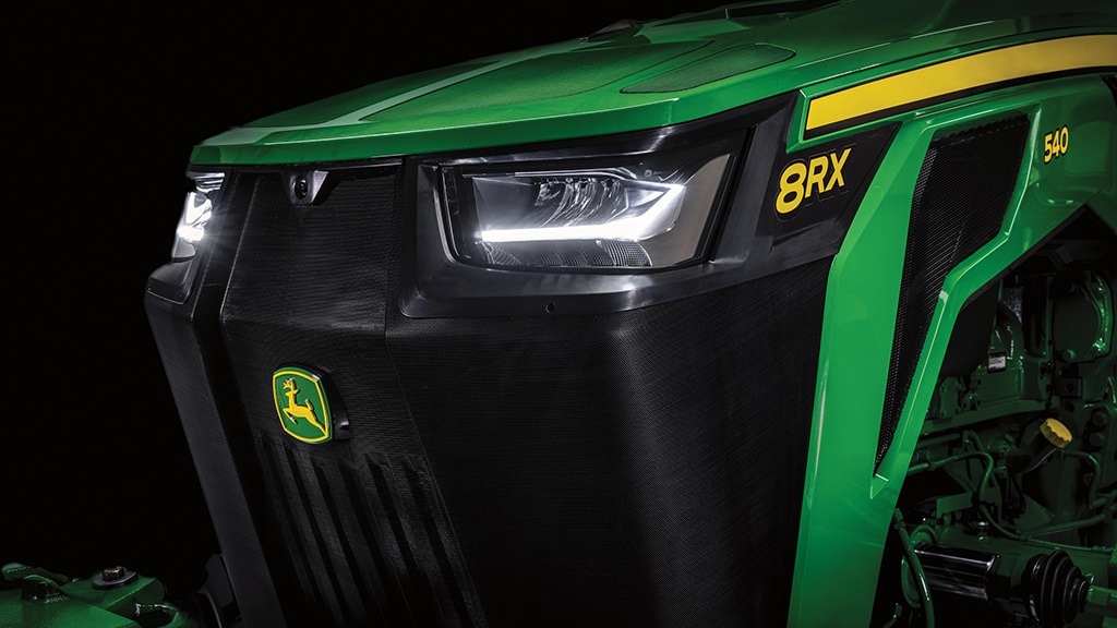Front image of 8 series tractors headlights and grill with a dark background
