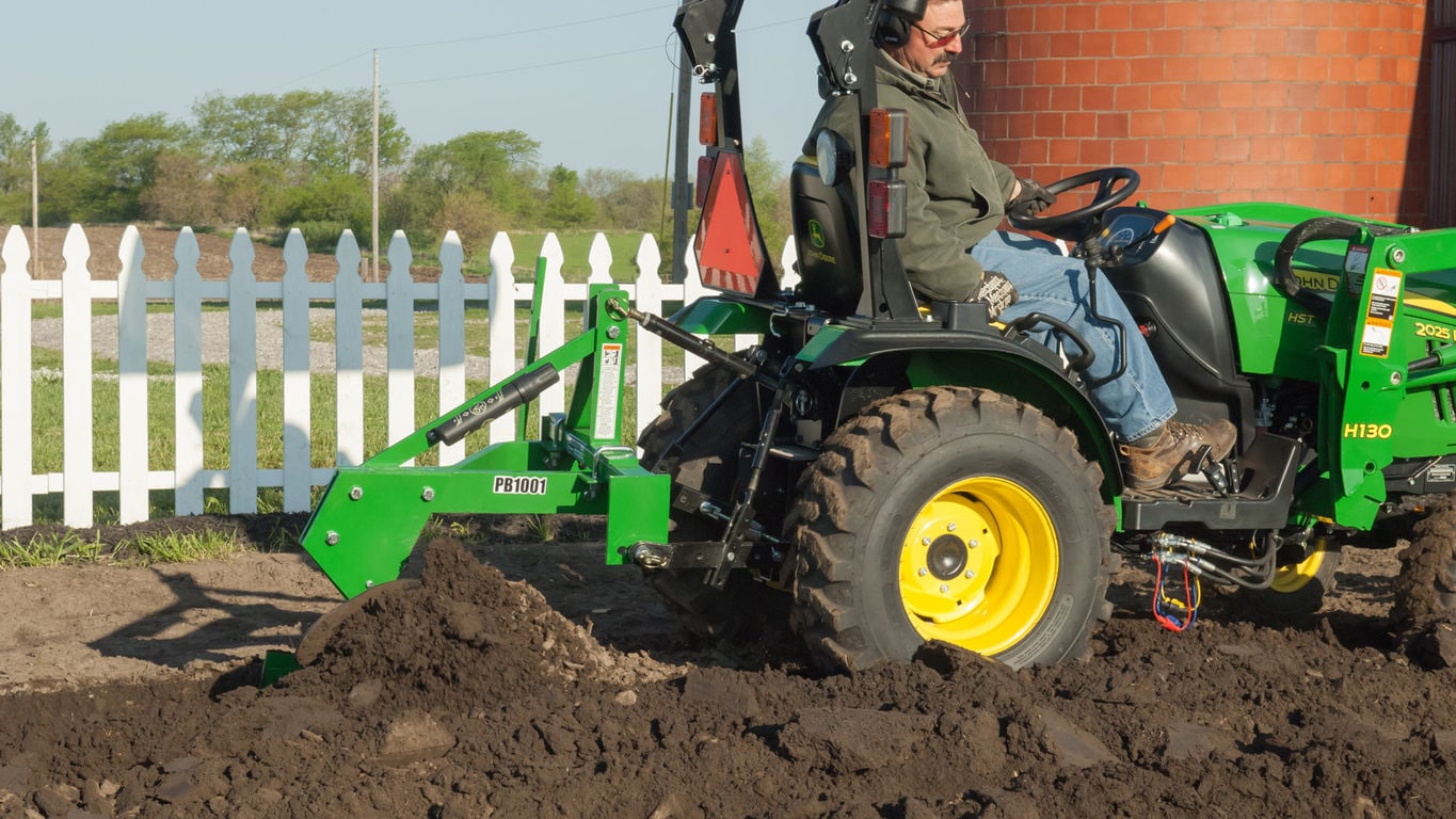 Frontier plow attached to tractor in dirt