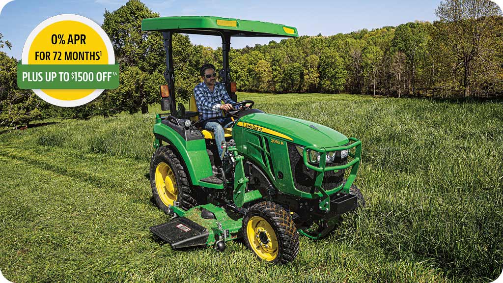 0% for 72 months, plus up to 1500 dollars off advertisement showing a man in the seat of a John Deere Series 2 compact tractor mowing tall grass.